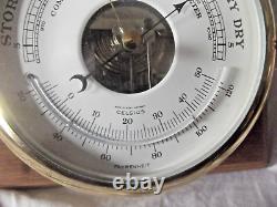 A Combination Barometer & Thermometer with a Ship Spell Clock both by Schatz