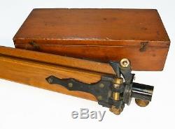 Cased antique surveyors level on period oak tripod stand, W F Stanley, 1920s